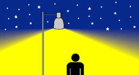 Silueta de persona iluminada por una farola en una noche estrellada